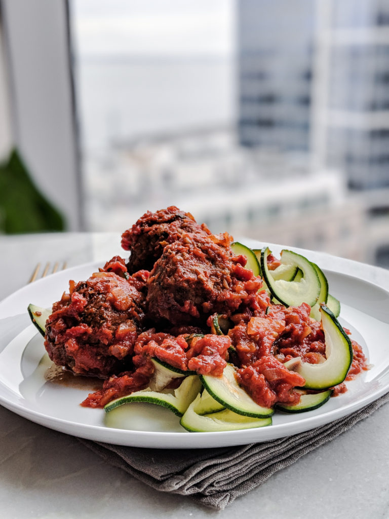 Instant Pot Italian Meatballs recipe with zucchini noodles on white plate 