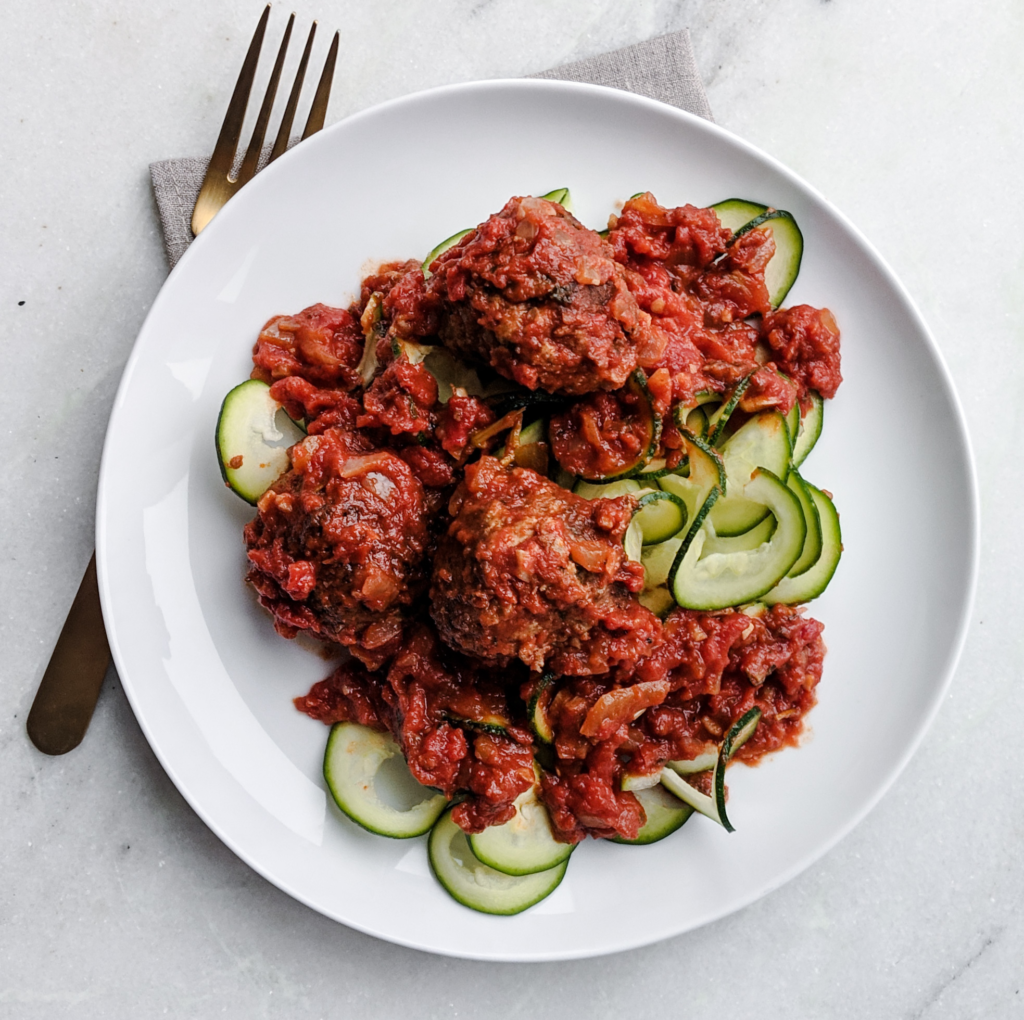 Instant Pot Italian Meatballs recipe with zucchini noodles on white plate 