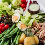 Close up of Nicoise salad on white platter
