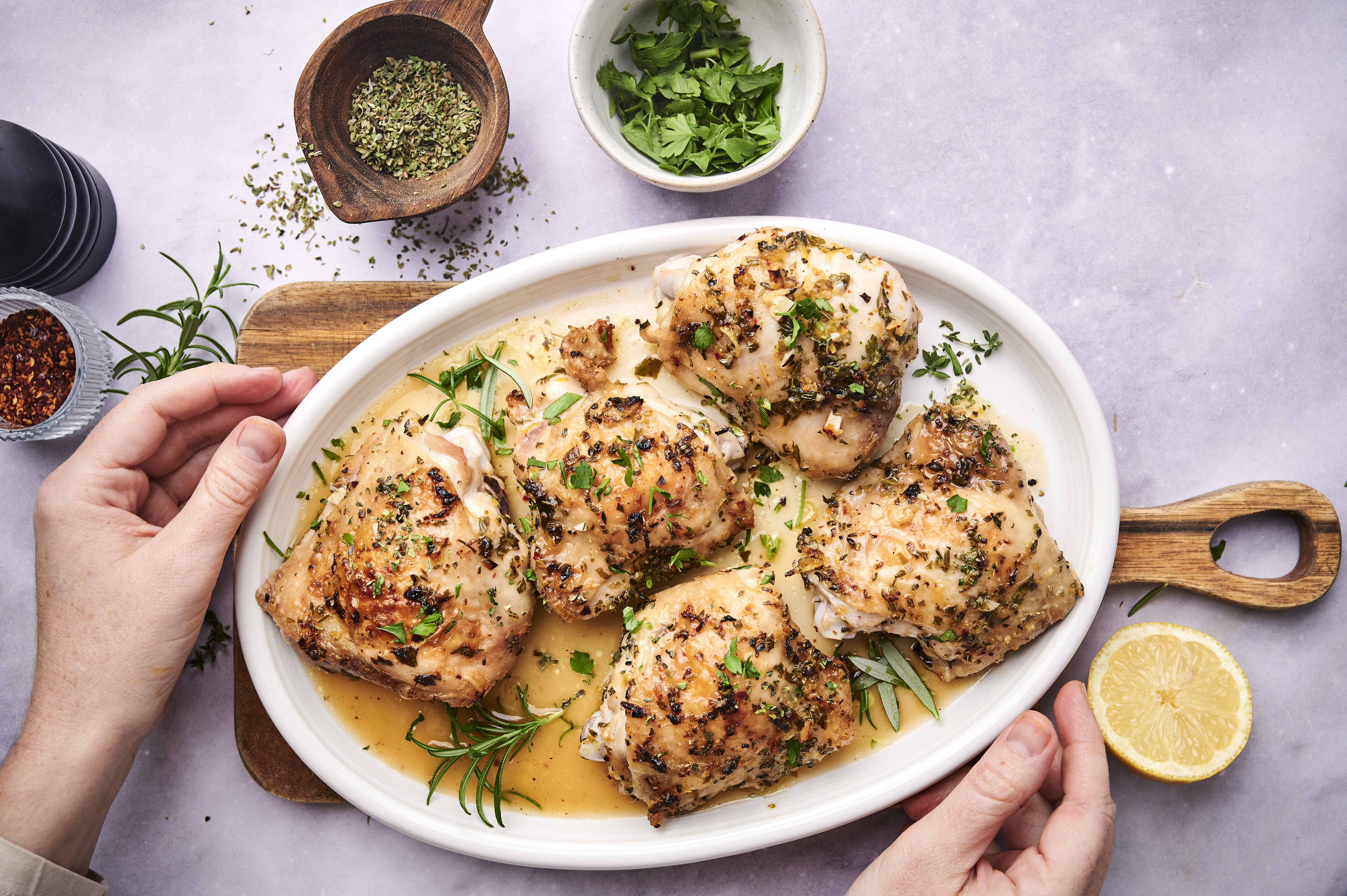 Herby chicken thighs on serving platter