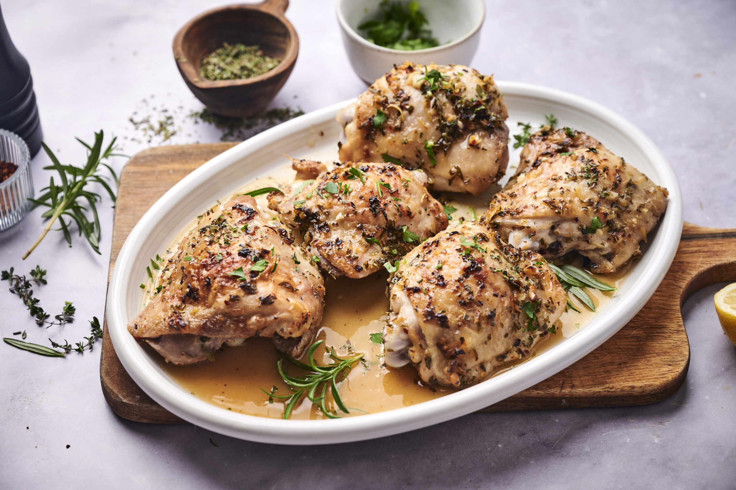 Herby chicken thighs on serving platter