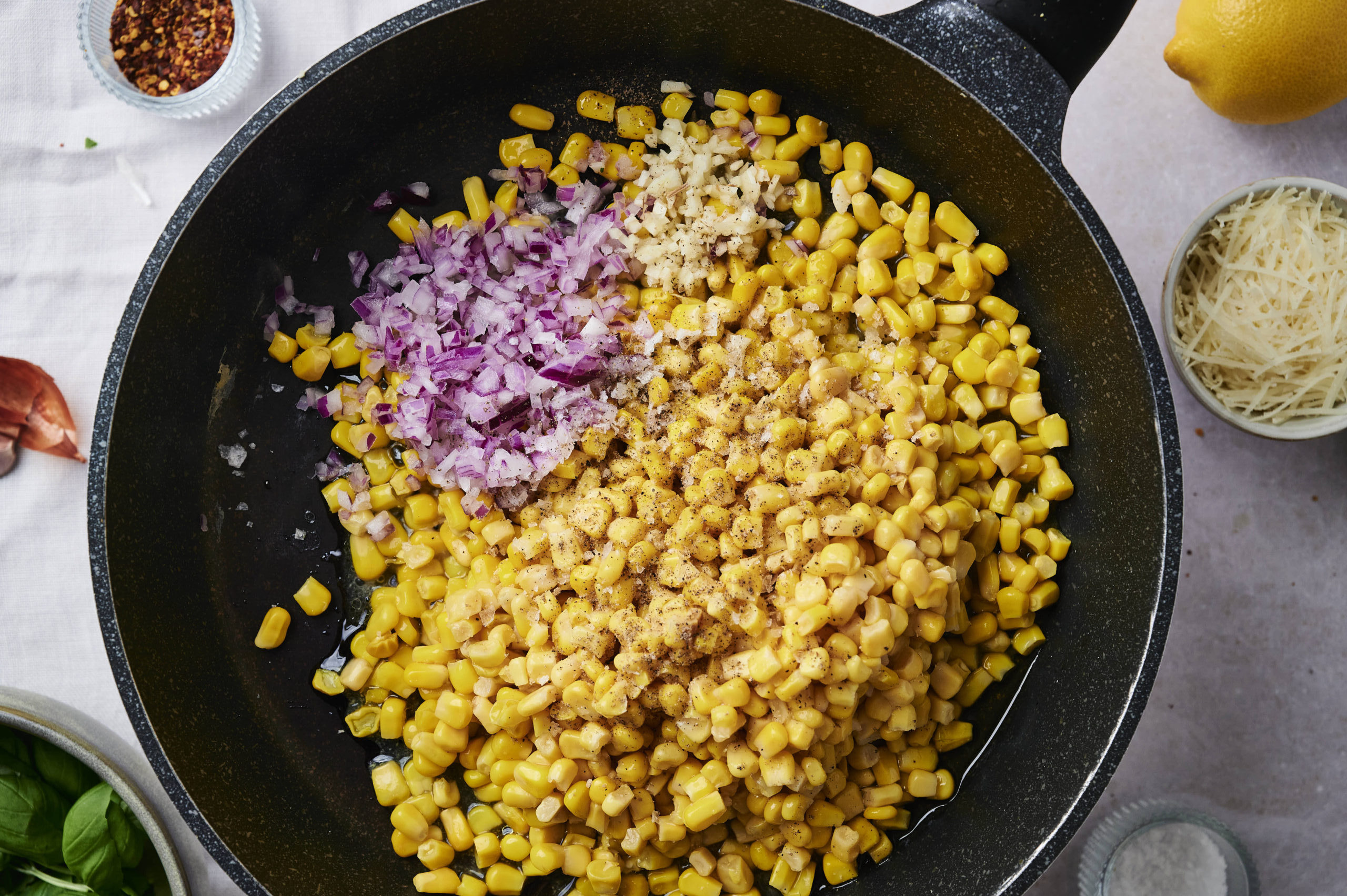 corn and shallot cooking in a pan 