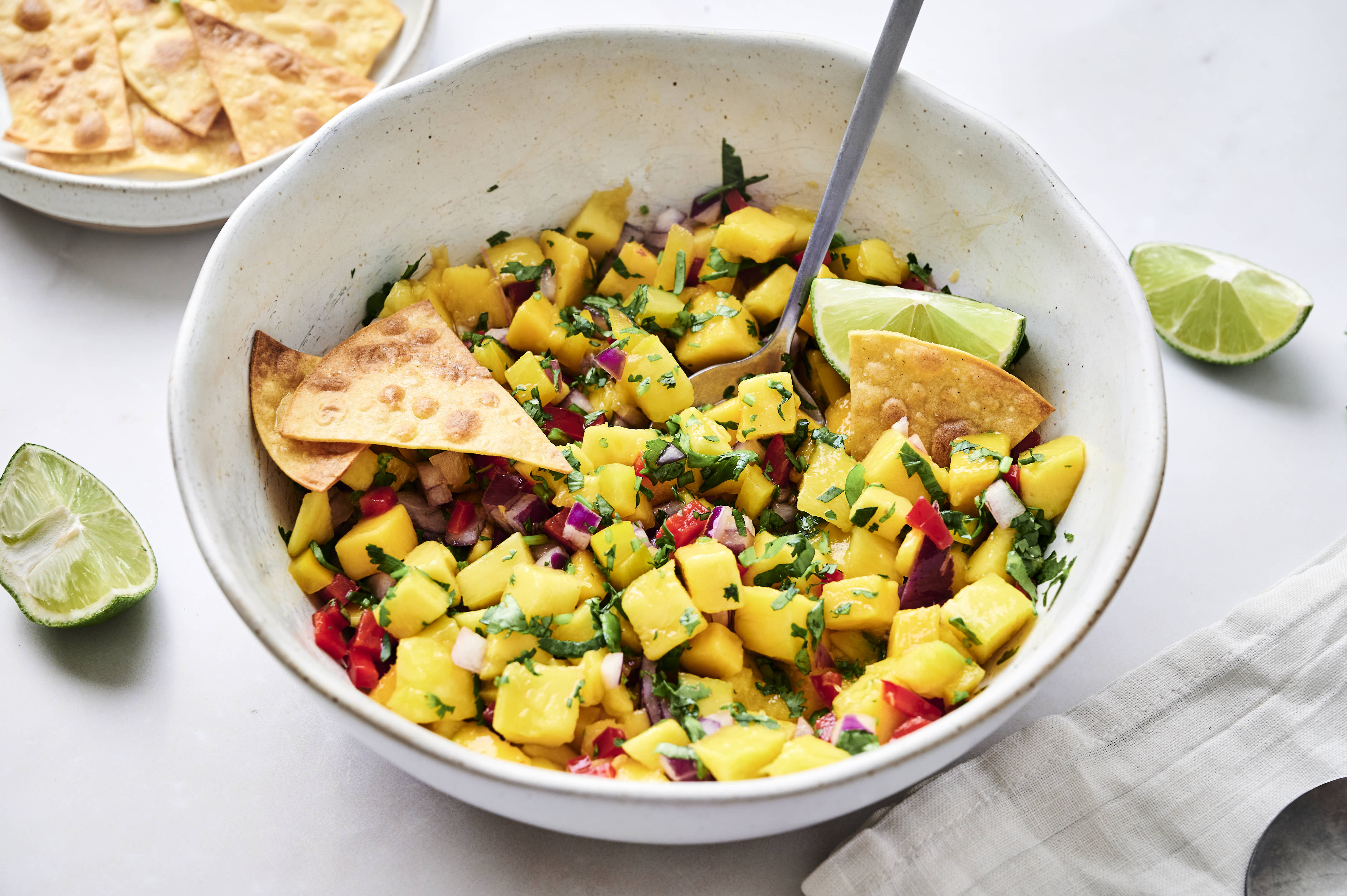 Fresh mango salsa in a bowl with chips. 