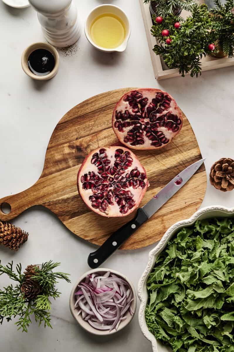 pomegranate cut open on cutting board 