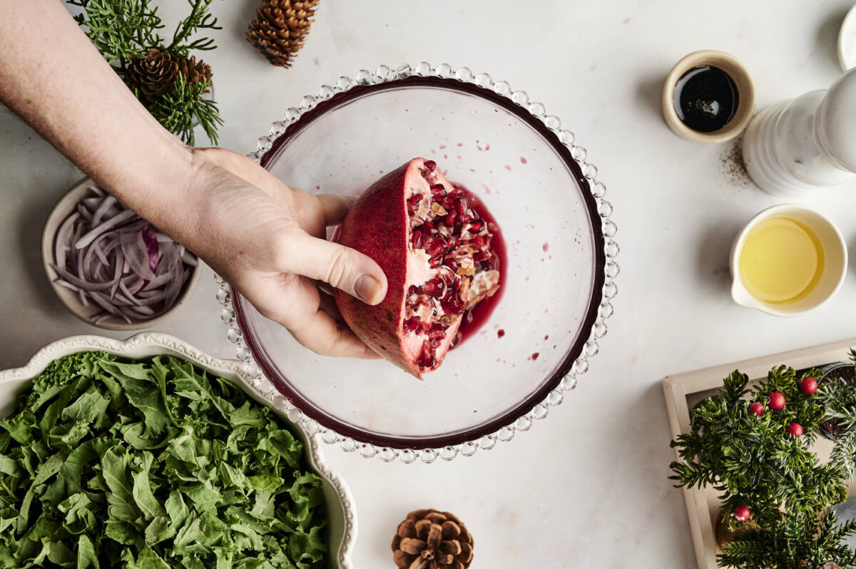 Removing pomegranate seeds into bowl