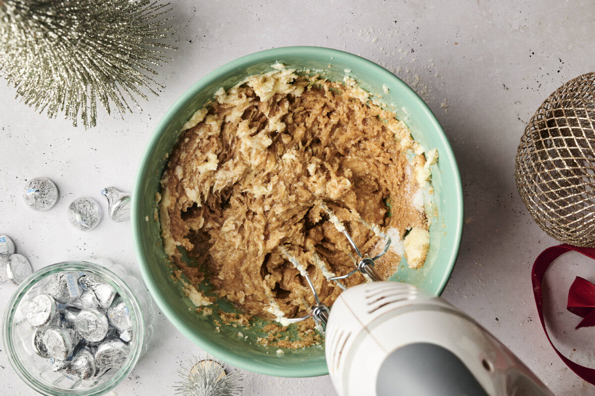 Mixing together peanut butter, butter and sugar 