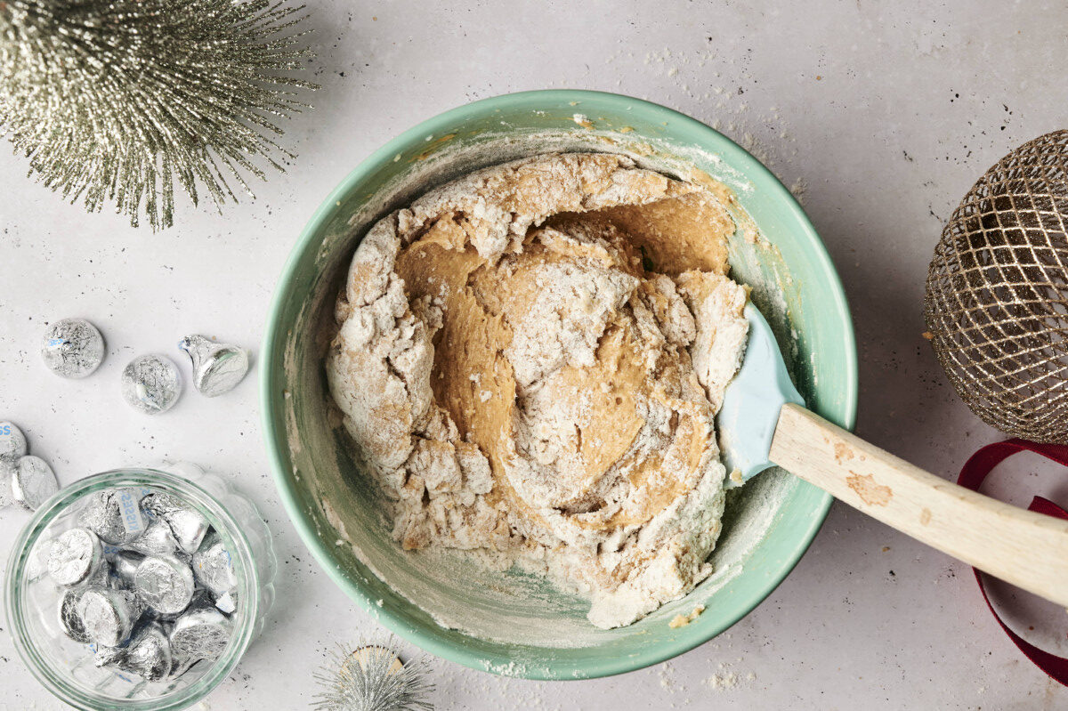 Mixing flour into the cookie batter 