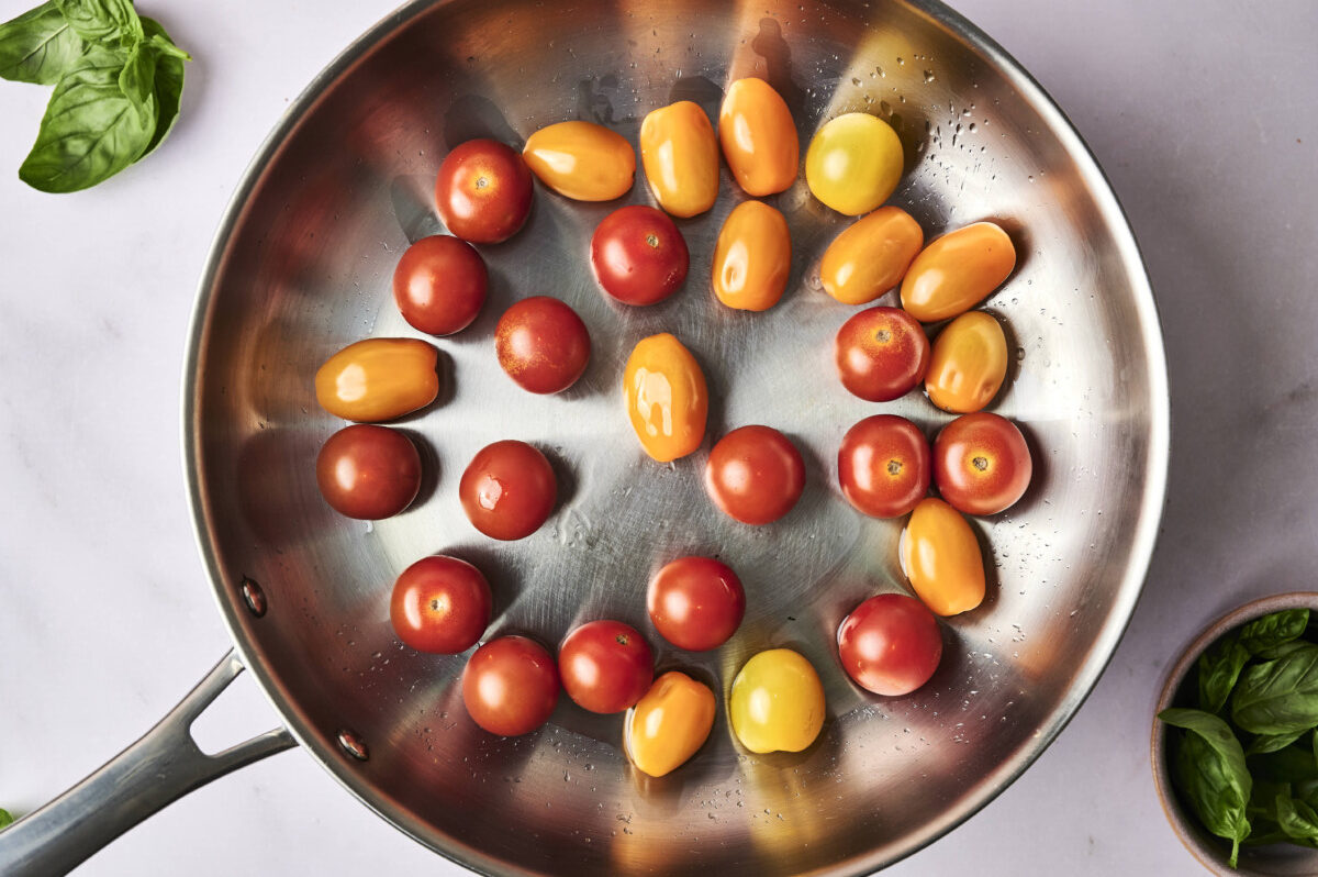 cherry tomatoes cooking in a pan