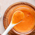 Orange sauce on spoon