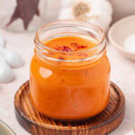 Orange taco sauce in glass jar