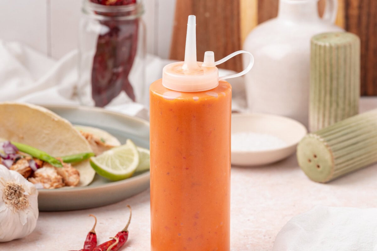Orange taco sauce in a squeeze bottle 